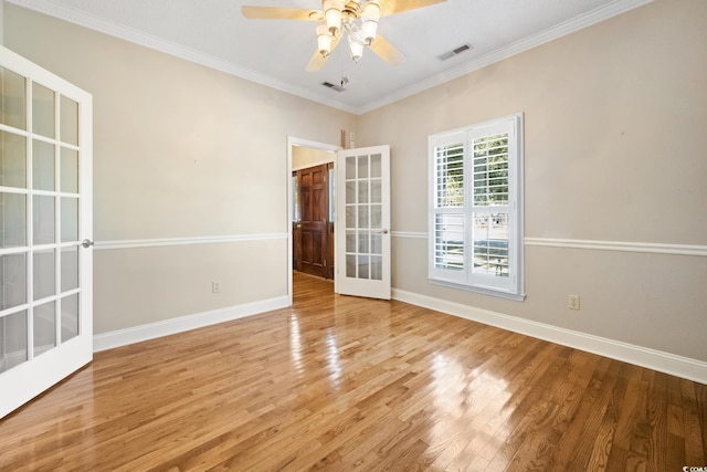 unfurnished room with french doors, hardwood / wood-style floors, ornamental molding, and ceiling fan