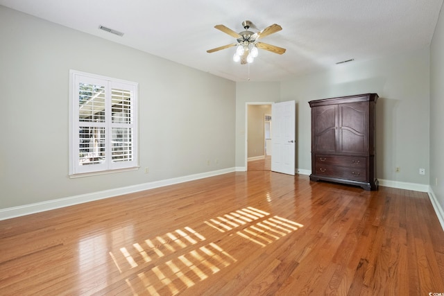 unfurnished bedroom featuring ceiling fan and hardwood / wood-style flooring