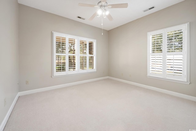 carpeted spare room with ceiling fan