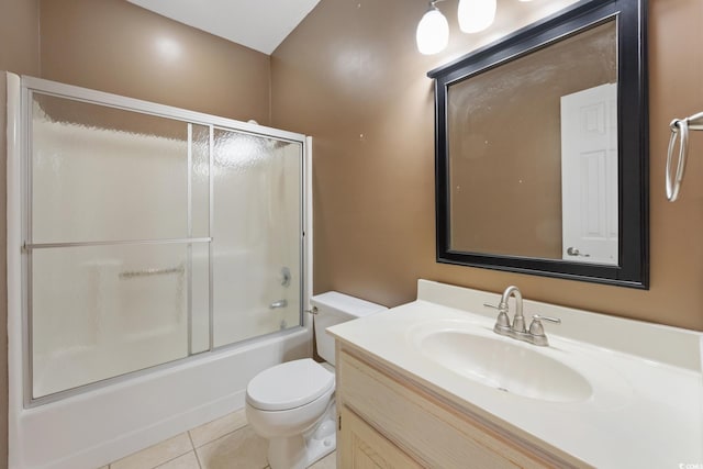 full bathroom featuring enclosed tub / shower combo, tile patterned flooring, vanity, and toilet