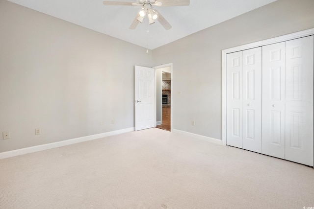 unfurnished bedroom featuring a closet, light carpet, and ceiling fan