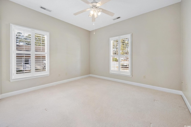 empty room with light colored carpet and ceiling fan