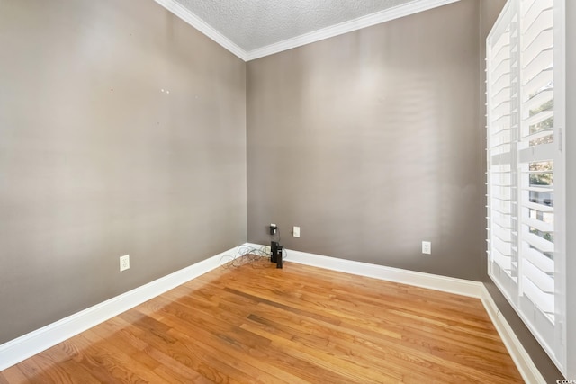 laundry room with a textured ceiling, hardwood / wood-style floors, and crown molding