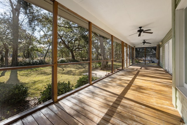 unfurnished sunroom featuring ceiling fan and a wealth of natural light