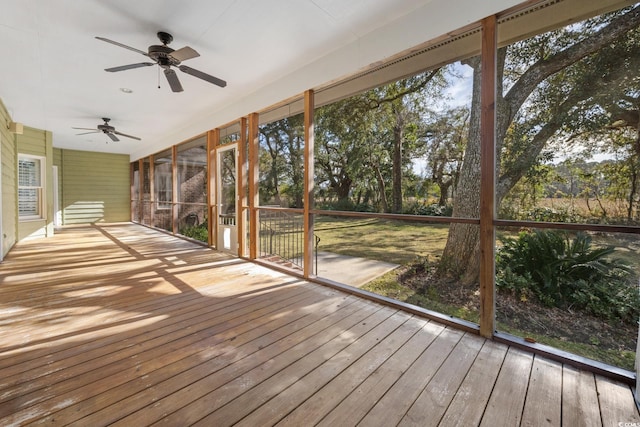 unfurnished sunroom featuring ceiling fan