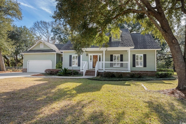 view of front facade with a garage, a porch, and a front lawn