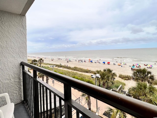 balcony with a beach view and a water view