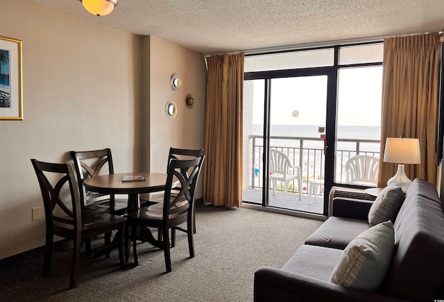 dining area featuring expansive windows, carpet floors, a water view, and plenty of natural light