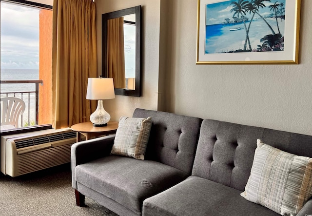 living area with a water view, a wealth of natural light, and an AC wall unit