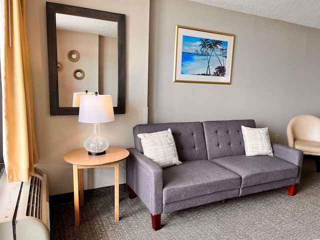 living room with carpet, radiator heating unit, and a textured ceiling