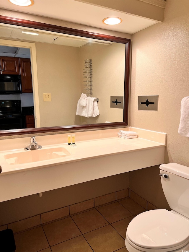 bathroom with tile patterned flooring, sink, and toilet