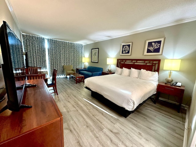 bedroom featuring hardwood / wood-style flooring and crown molding