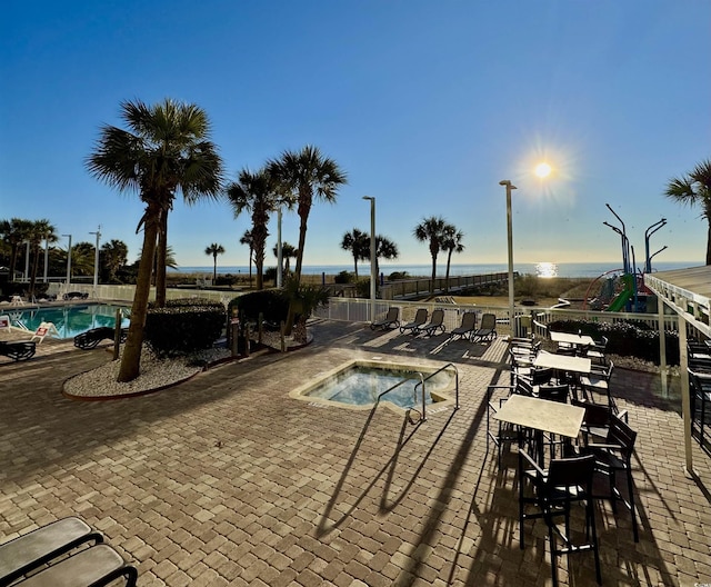 view of pool featuring a patio area and a hot tub