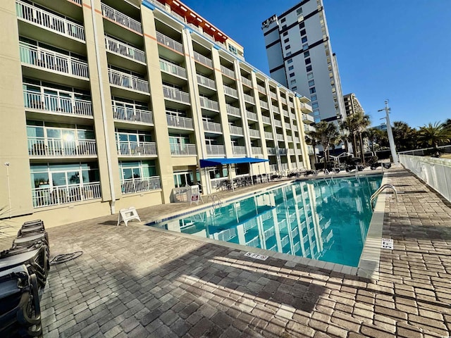 view of swimming pool featuring a patio