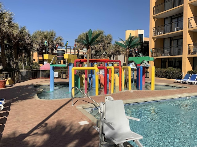 view of pool with a playground