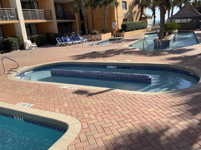 6900 N Ocean Blvd Unit 614, Myrtle Beach, SC 29572 - community pool featuring a patio area and a community hot tub