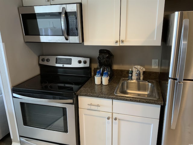 6900 N Ocean Blvd Unit 614, Myrtle Beach, SC 29572 - kitchen with stainless steel appliances, a sink, and white cabinets