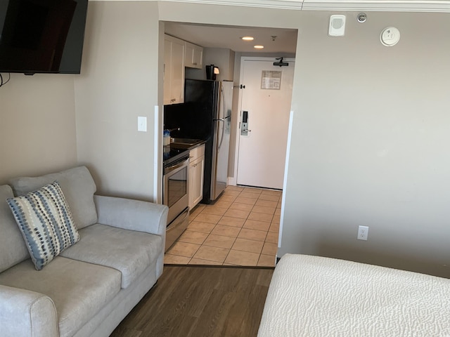 6900 N Ocean Blvd Unit 614, Myrtle Beach, SC 29572 - kitchen with electric range, white cabinets, light wood-style flooring, open floor plan, and recessed lighting