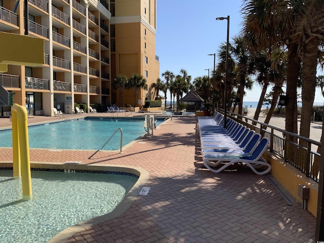 6900 N Ocean Blvd Unit 614, Myrtle Beach, SC 29572 - community pool featuring a patio area