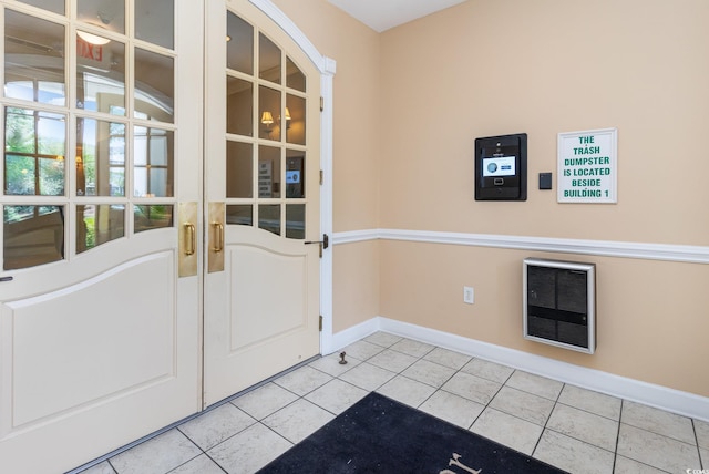 entryway featuring light tile patterned floors and heating unit