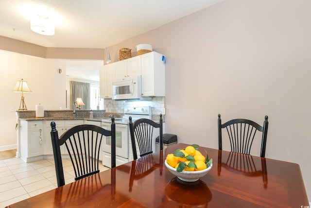 tiled dining space featuring sink