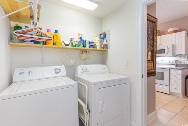 laundry area with light tile patterned floors and independent washer and dryer