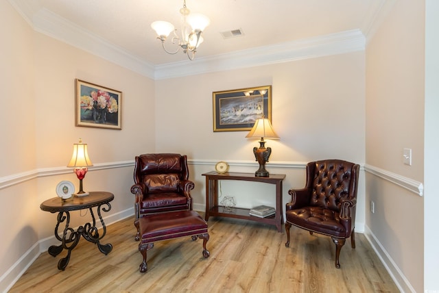 sitting room with an inviting chandelier, crown molding, and light hardwood / wood-style flooring