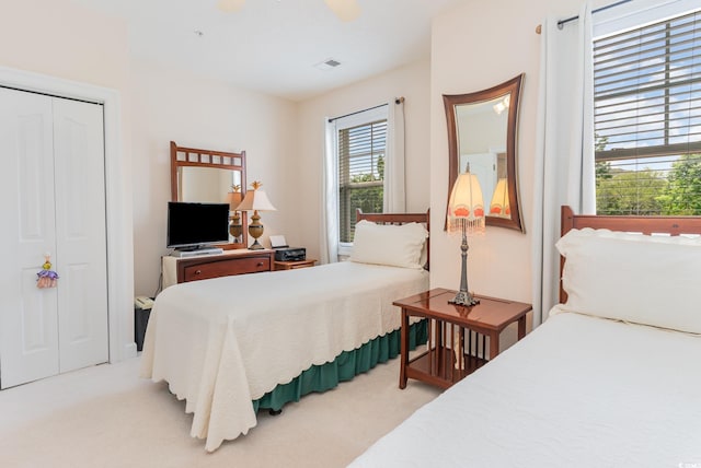 carpeted bedroom with a closet and ceiling fan