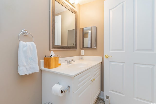 bathroom with vanity and a textured ceiling