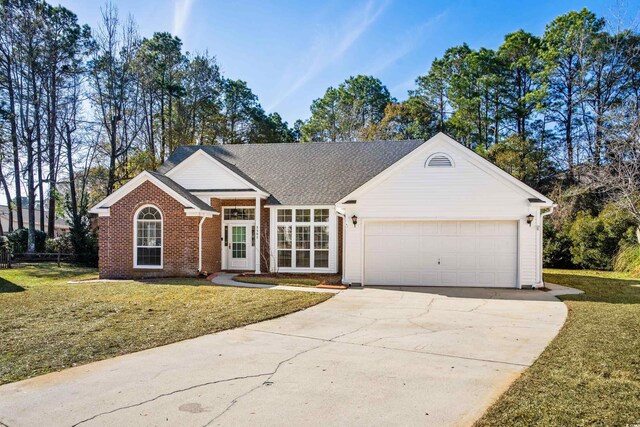 single story home featuring a front yard and a garage