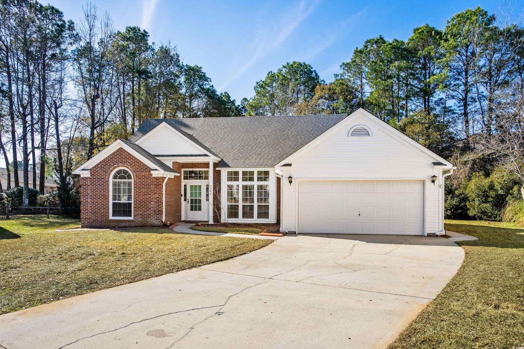 single story home featuring a front yard and a garage