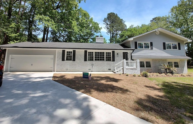 106 Governor Boone Ln, Georgetown, SC 29440 - tri-level home with an attached garage, brick siding, a chimney, and concrete driveway
