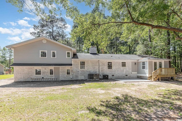 106 Governor Boone Ln, Georgetown, SC 29440 - rear view of property with a chimney, a lawn, central AC unit, a wooden deck, and a patio