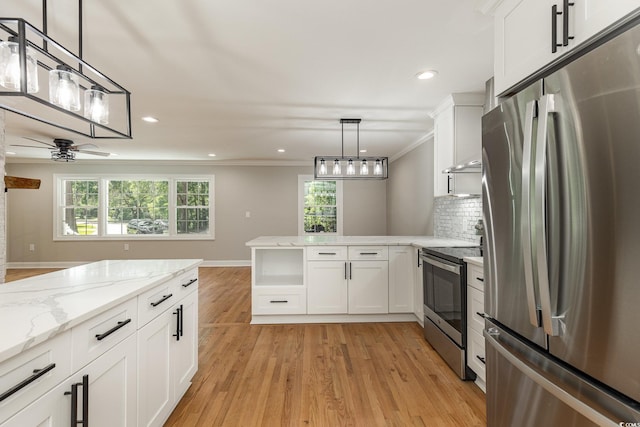 106 Governor Boone Ln, Georgetown, SC 29440 - kitchen with white cabinetry, a peninsula, light wood finished floors, and stainless steel appliances