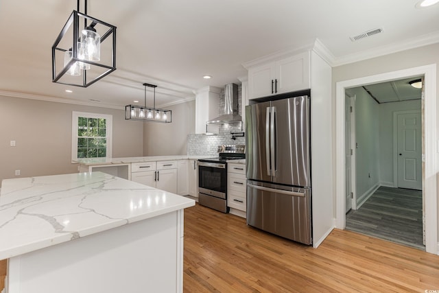 106 Governor Boone Ln, Georgetown, SC 29440 - kitchen featuring visible vents, a peninsula, wall chimney exhaust hood, light wood-style flooring, and stainless steel appliances