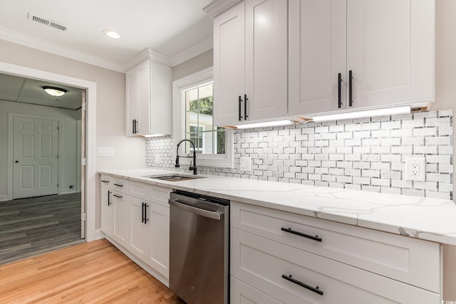 106 Governor Boone Ln, Georgetown, SC 29440 - kitchen featuring light wood-type flooring, white cabinetry, light stone counters, a sink, and dishwasher