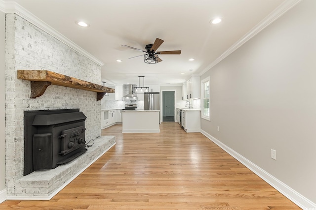 106 Governor Boone Ln, Georgetown, SC 29440 - unfurnished living room featuring ceiling fan, baseboards, light wood-style floors, ornamental molding, and recessed lighting