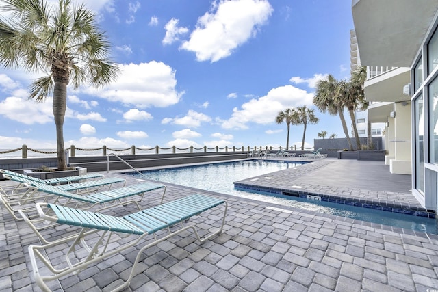 community pool with a patio area