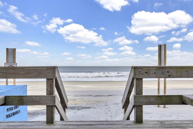 view of home's community with a beach view and a water view