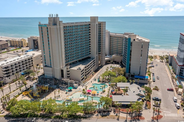 drone / aerial view featuring a water view and a beach view