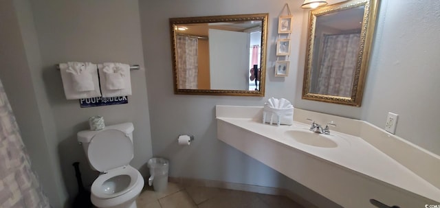 bathroom with tile patterned flooring, sink, and toilet