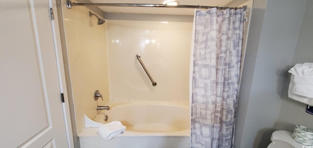 bathroom with shower / bath combination with curtain and toilet