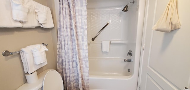 bathroom with toilet and shower / bath combo