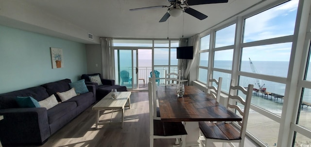 dining room featuring hardwood / wood-style flooring, ceiling fan, and floor to ceiling windows