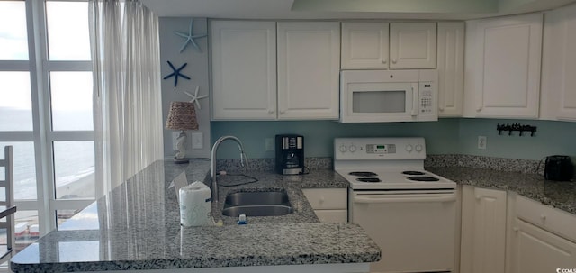 kitchen with white cabinetry, white appliances, plenty of natural light, and sink