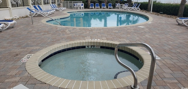 view of pool featuring a hot tub