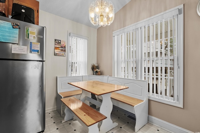 dining room with a notable chandelier and a healthy amount of sunlight