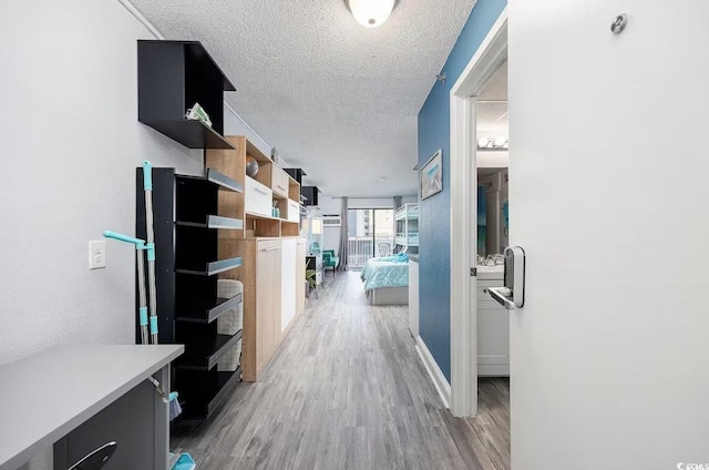 hallway featuring a textured ceiling, hardwood / wood-style flooring, and expansive windows