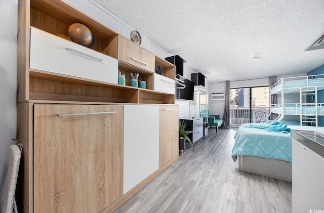 kitchen featuring light hardwood / wood-style floors and a textured ceiling