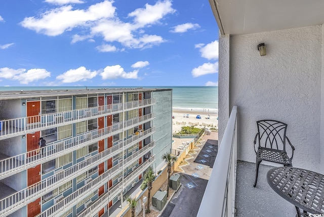 balcony featuring a water view and a view of the beach